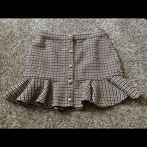 Rust orange plaid skirt with ruffles on the bottom